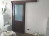Porte in legno massello restaurate e laccate bianco avorio con vetri satinati. Foto 1 prima.